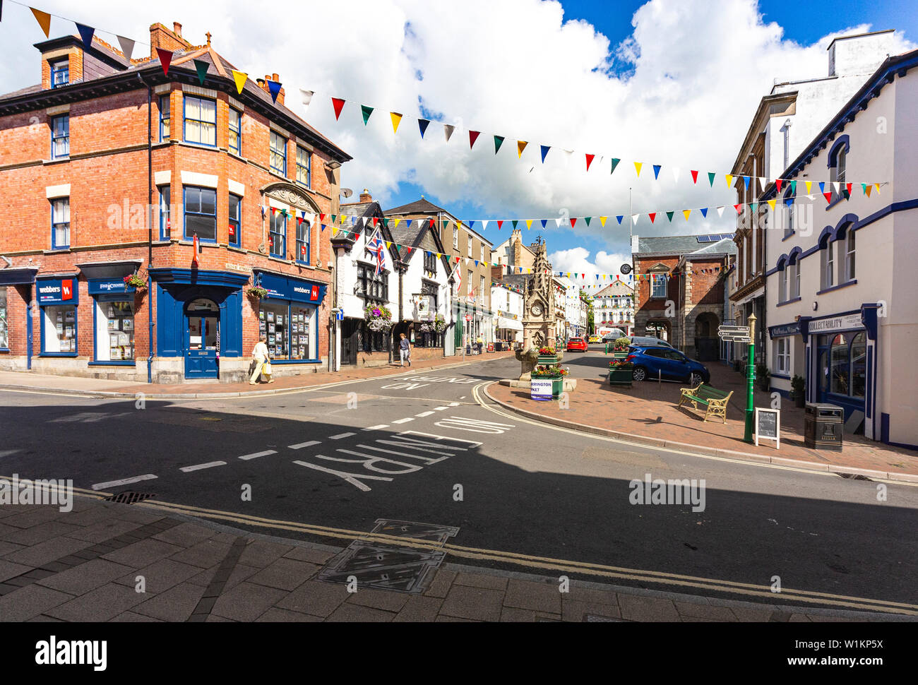 Town Centre Summer View From Great Torrington Pannier Market: The Square with Clock Tower, Bright Flowers, Town Hall and Buildings; Great Torrington, Stock Photo