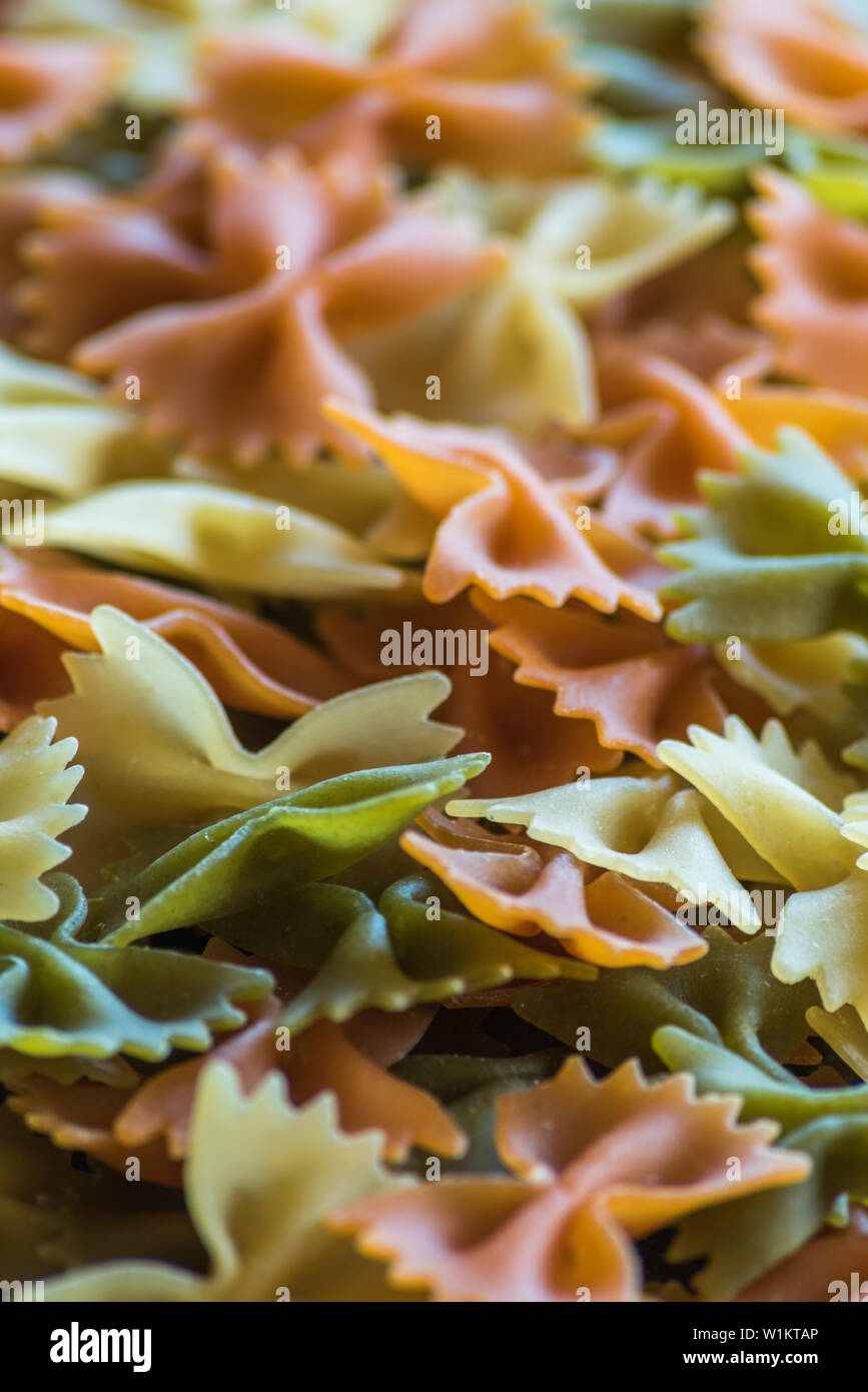 Colorful pasta bow ties background Stock Photo - Alamy