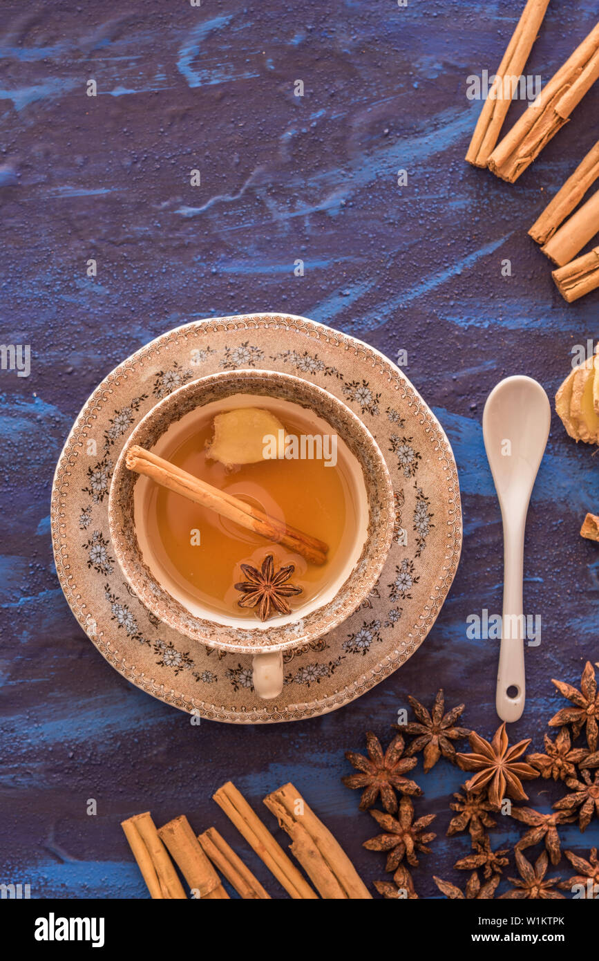 Ginger tea with anise and cinnamon served in cup with a blue background Stock Photo