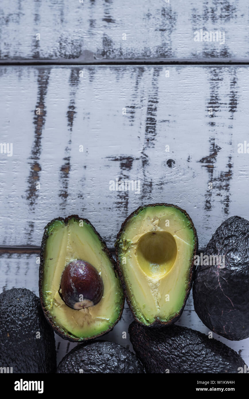 Ripe avocados on a with wooden background Stock Photo - Alamy