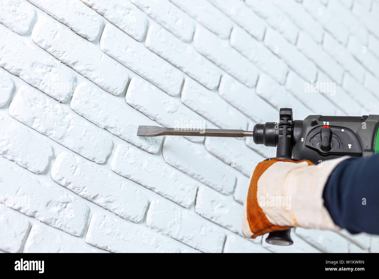 Use hammer drill to drill the wall Stock Photo Alamy