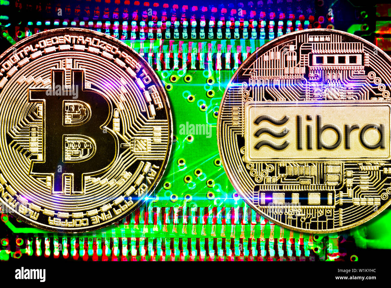 Bitcoin and libra cryptocurrency coins on computer circuit board Stock Photo