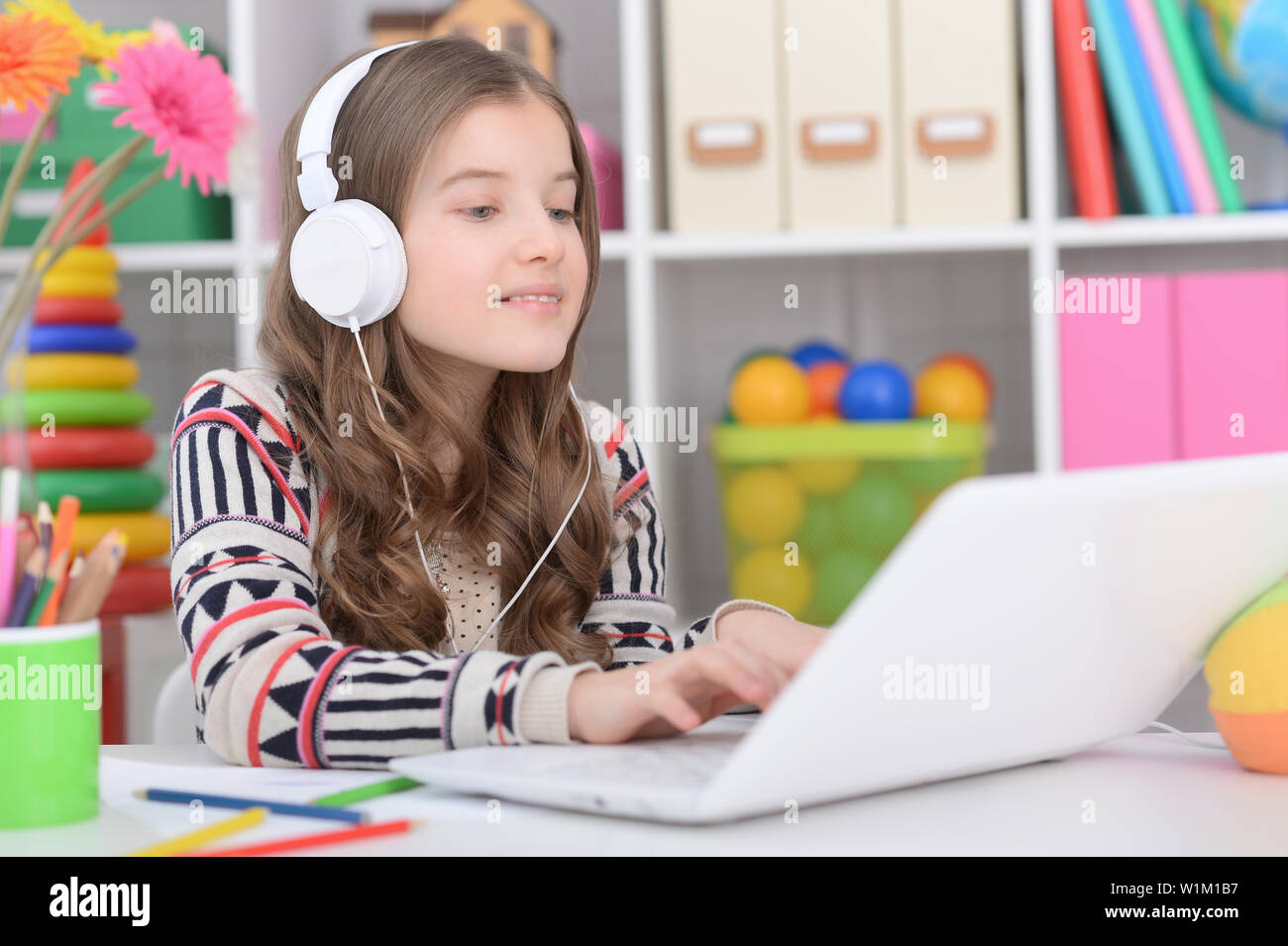 Portrait of little girl using modern laptop Stock Photo - Alamy