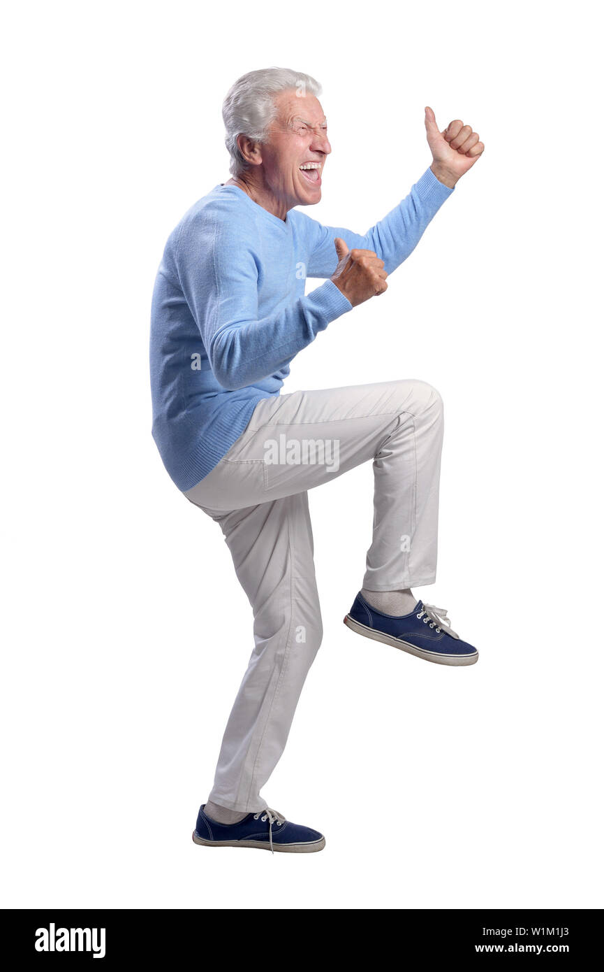Portrait of happy senior man showing thumbs up isolated on white ...