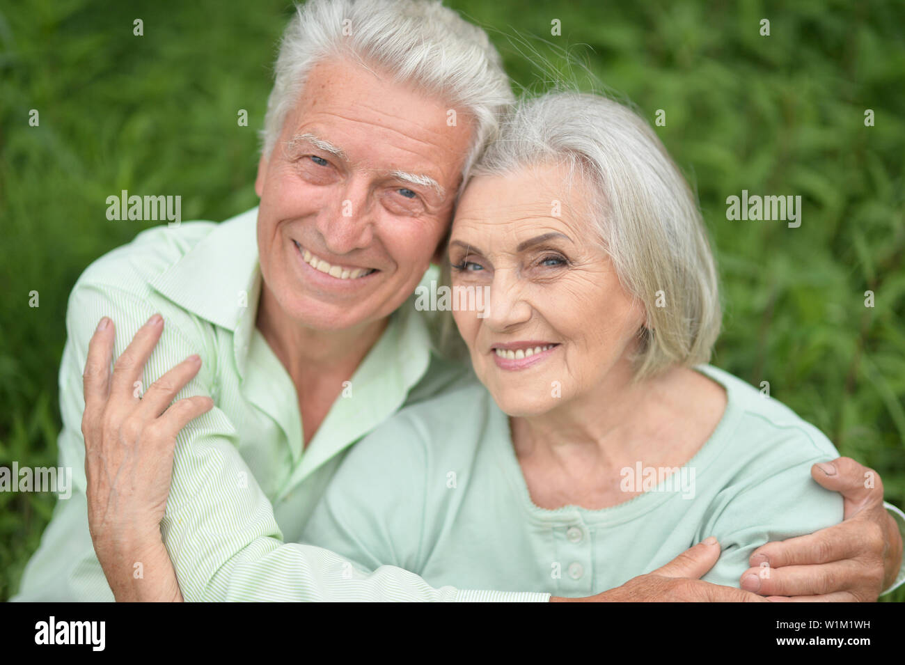 Beautiful senior couple posing in the park Stock Photo - Alamy