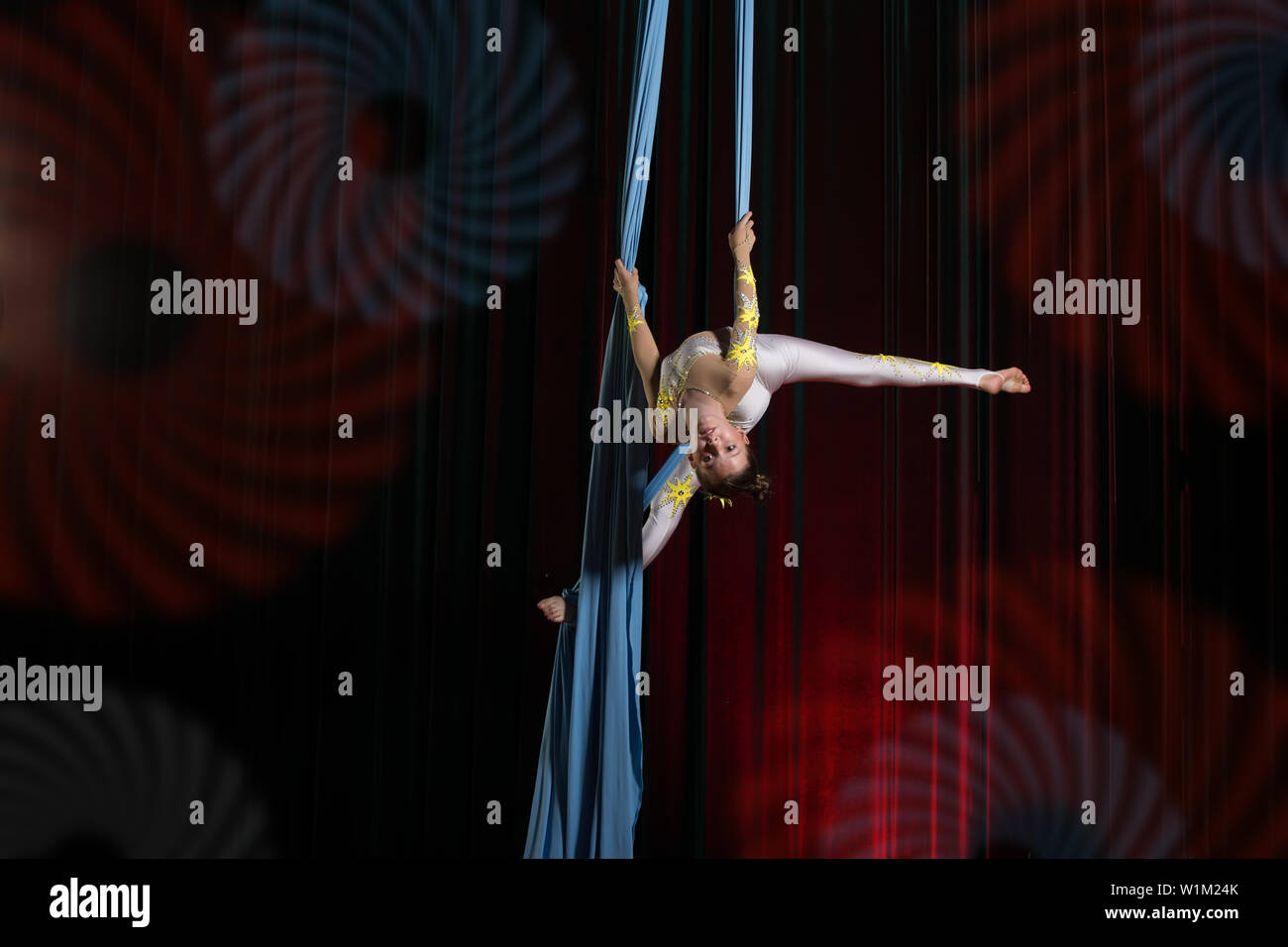 Circus artist acrobat performance on canvases. The girl perform acrobatic elements in the air. Stock Photo