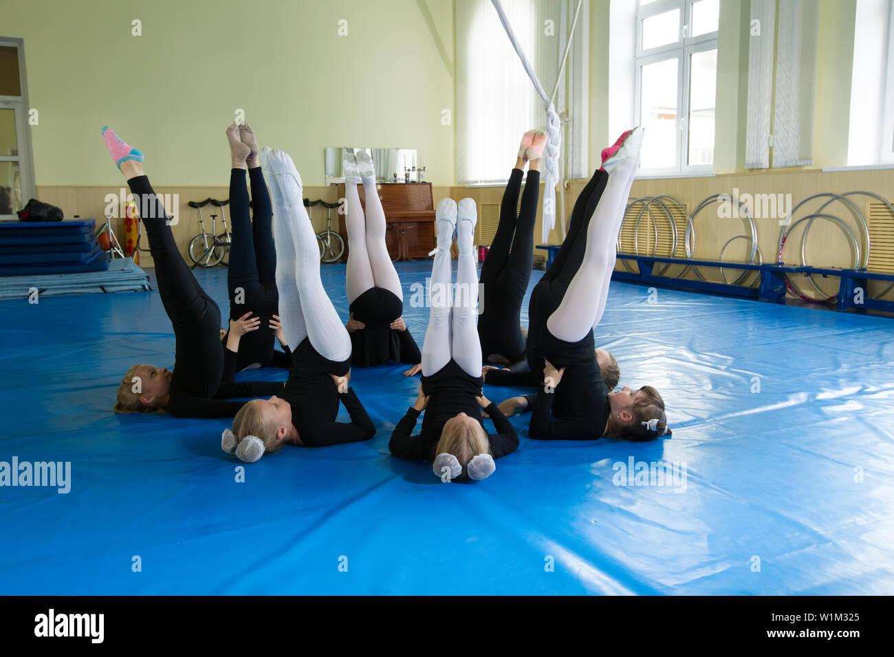 Young gymnasts doing exercises. Classes at the choreographic school. Physical education class