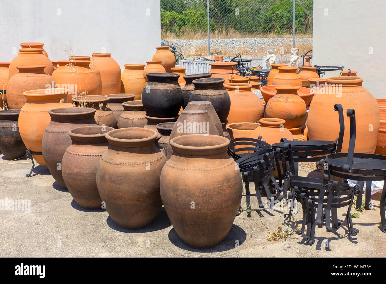 Many large orange clay vases outdoors at pottery shop in Portugal Stock Photo