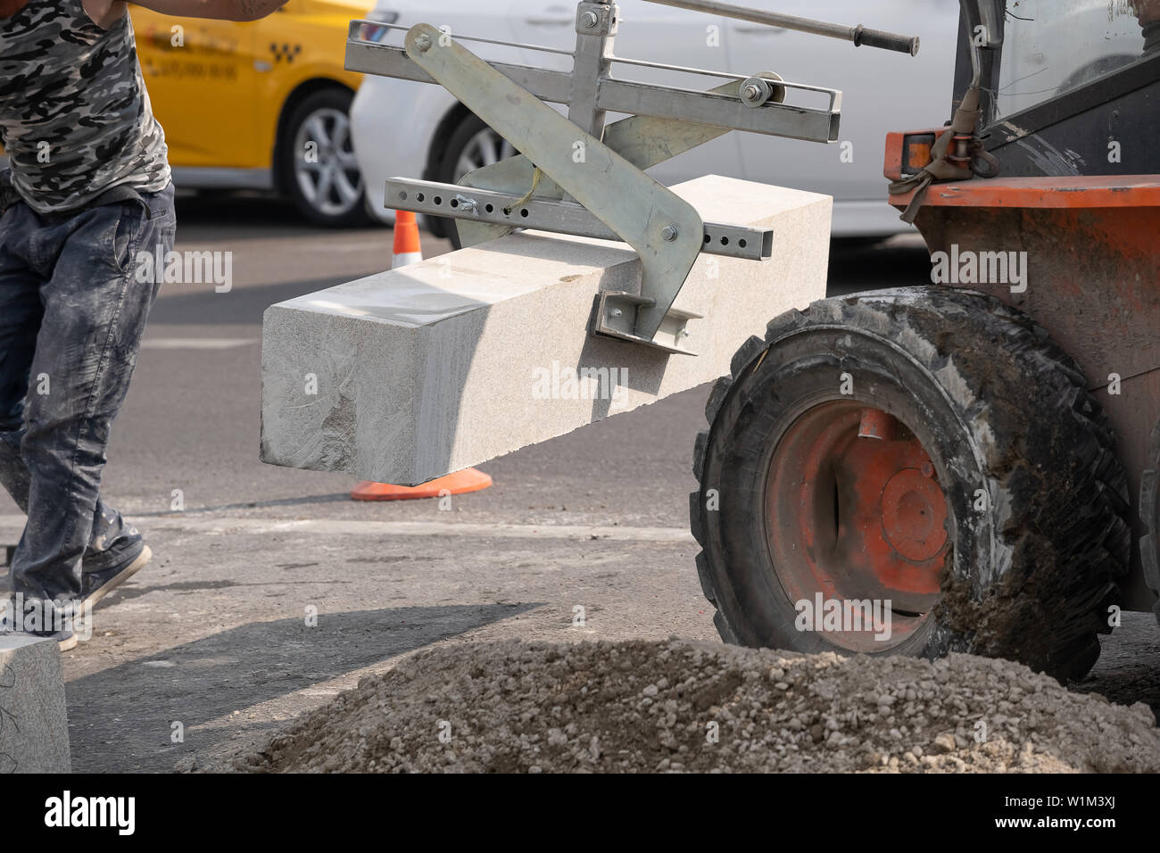 description: Installing pavement curb level and rubber hammers. Stock Photo