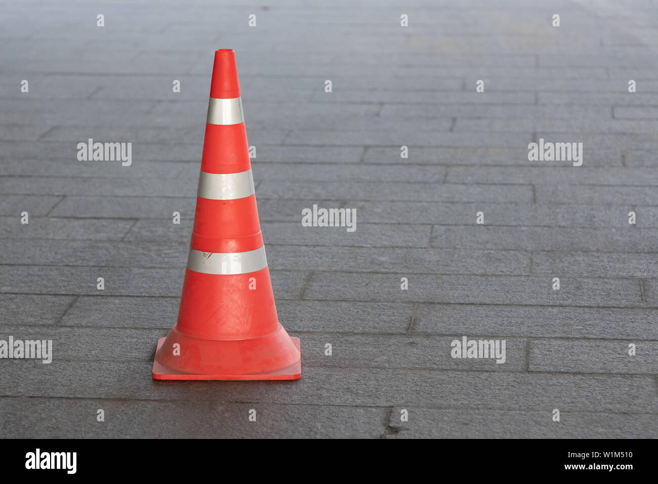 description: Plastic orange traffic cone on city street Stock Photo