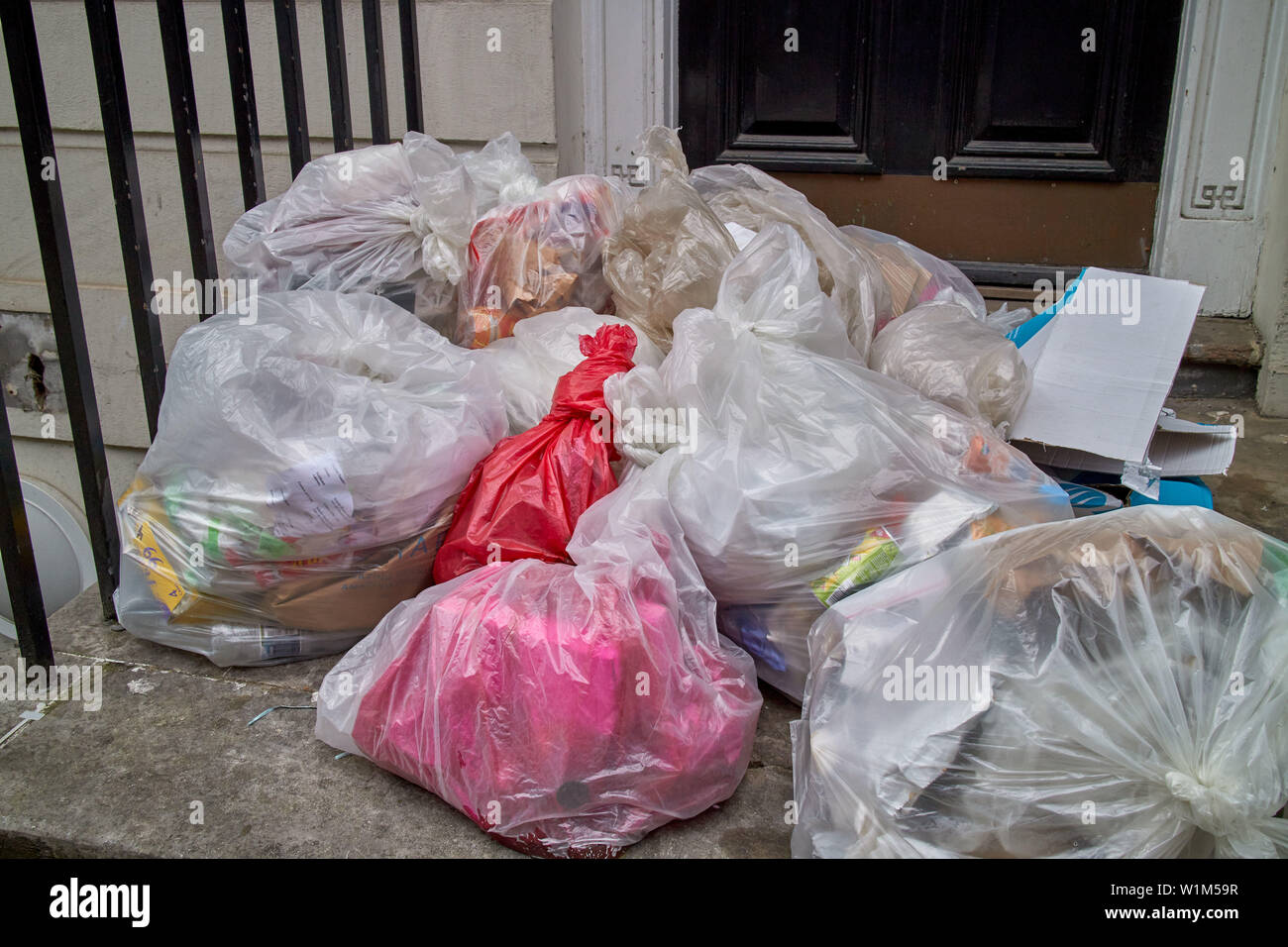 Bags of rubbish left on the doorstep of a central London property. Stock Photo