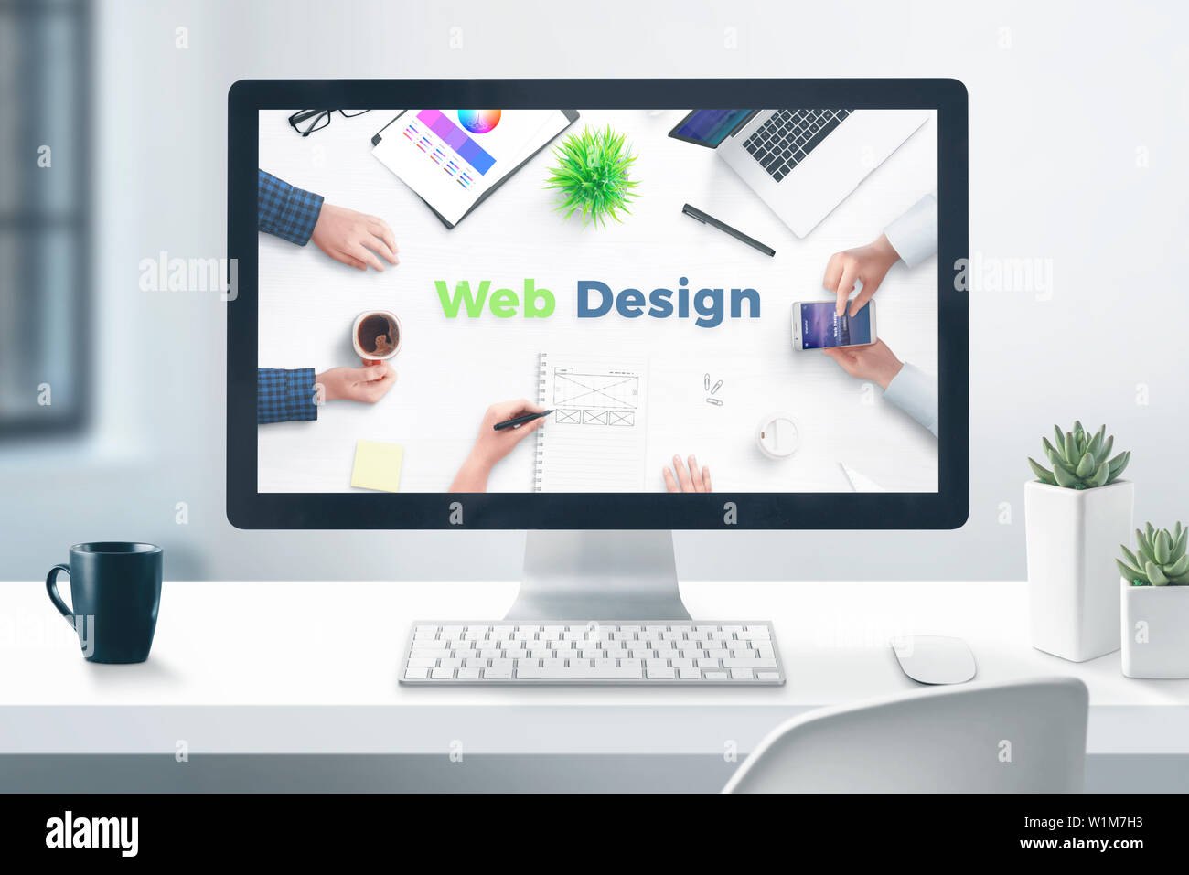Web design studio concept. Desktop computer display on flat office desk. Close-up. Stock Photo
