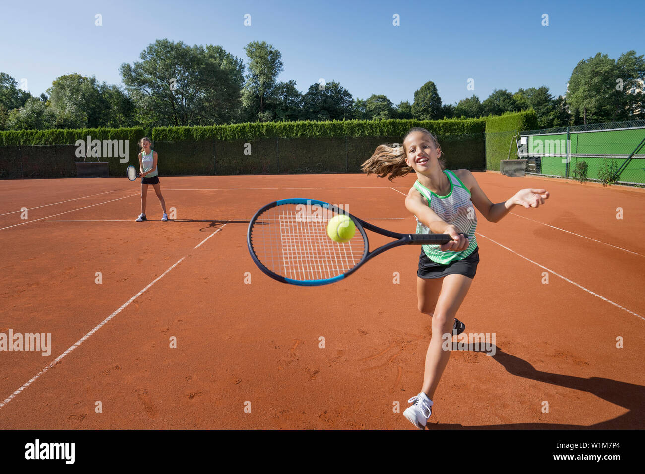Girls playing tennis on a sunny day, Bavaria, Germany Stock Photo - Alamy
