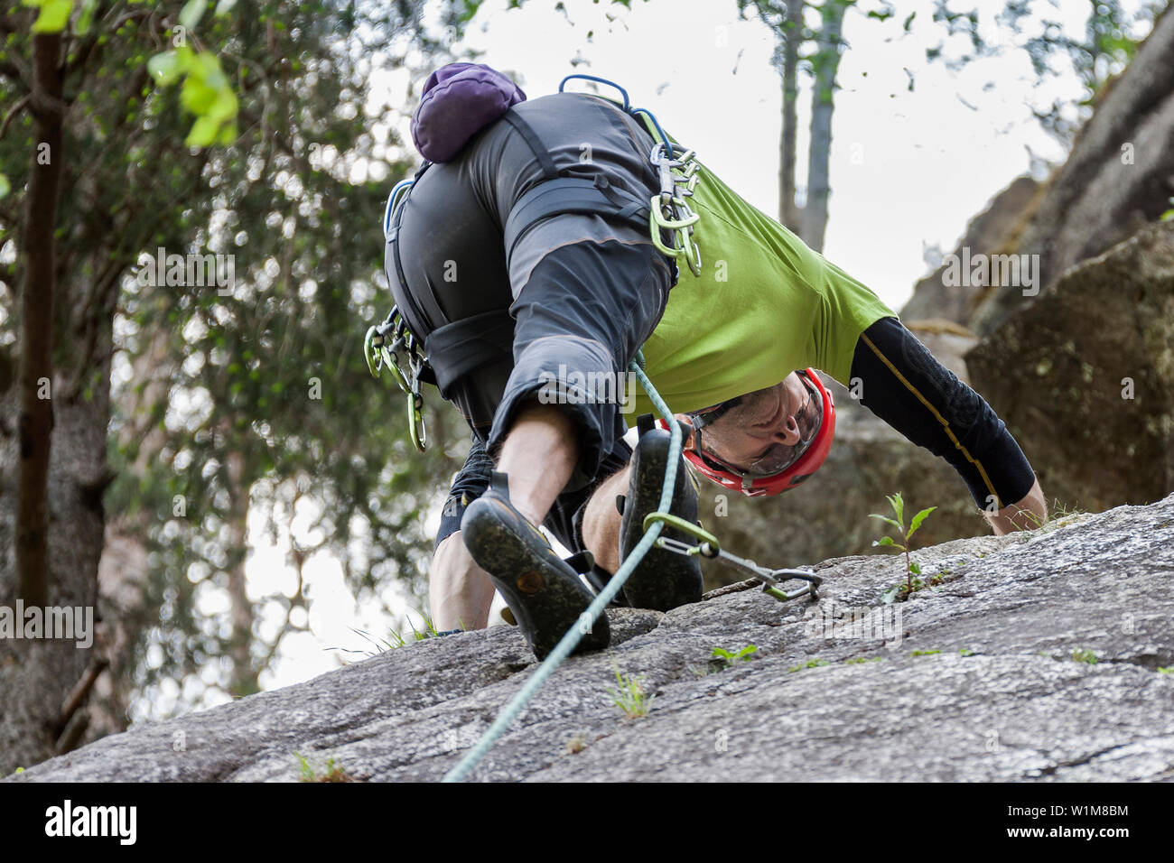 Male rock climber scaling a rock face at Oberried climbing garden, Otztal, Tyrol, Austria Stock Photo