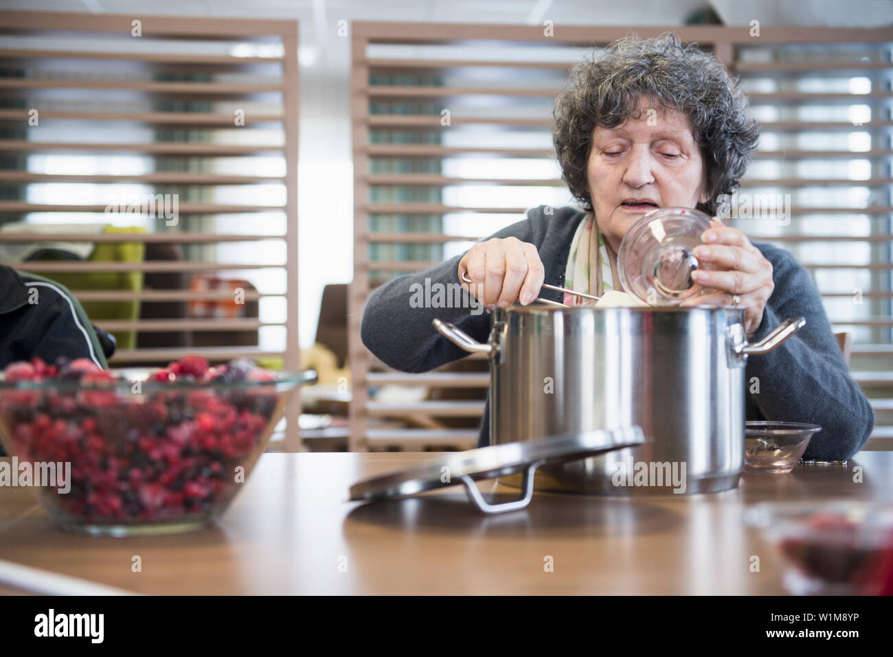 Senior woman preparing marmalade in rest home Stock Photo