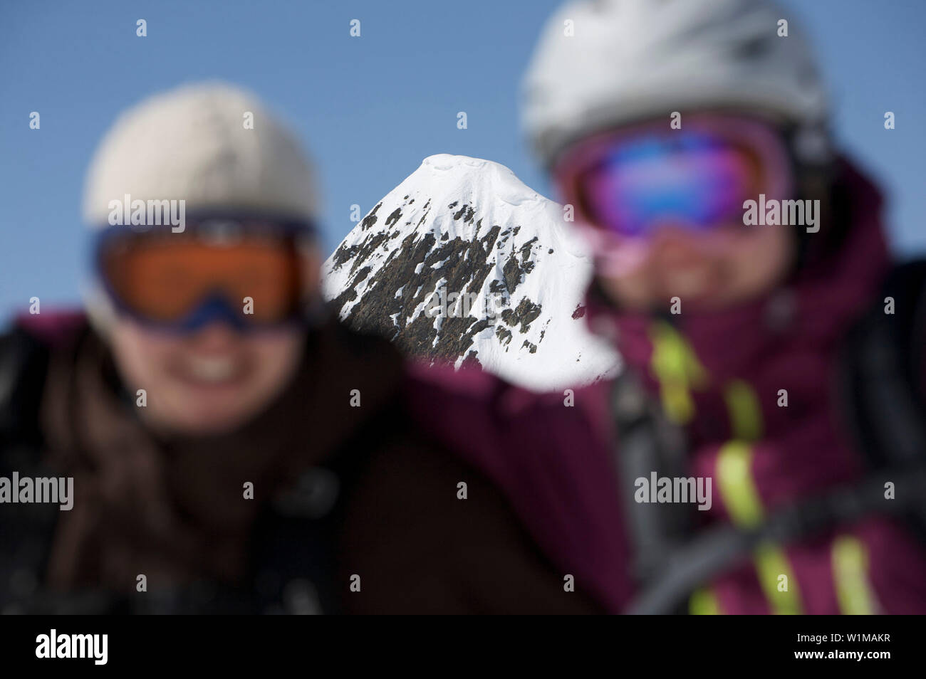 Two female skiers in front of a mountain, Kappl, Tyrol, Austria Stock Photo