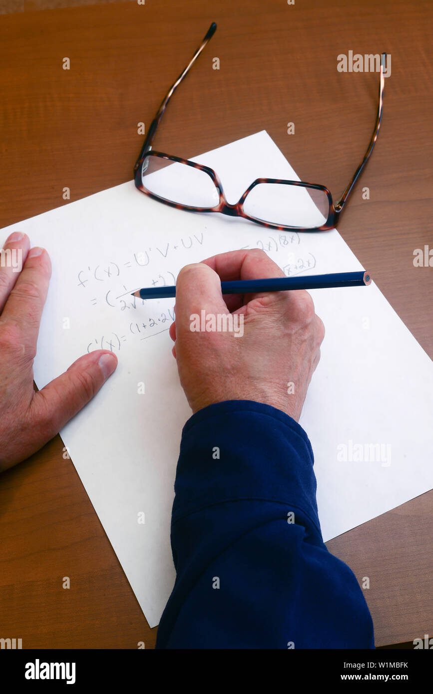 Derivative is worked out to find a true proof that the equation works . Stock Photo