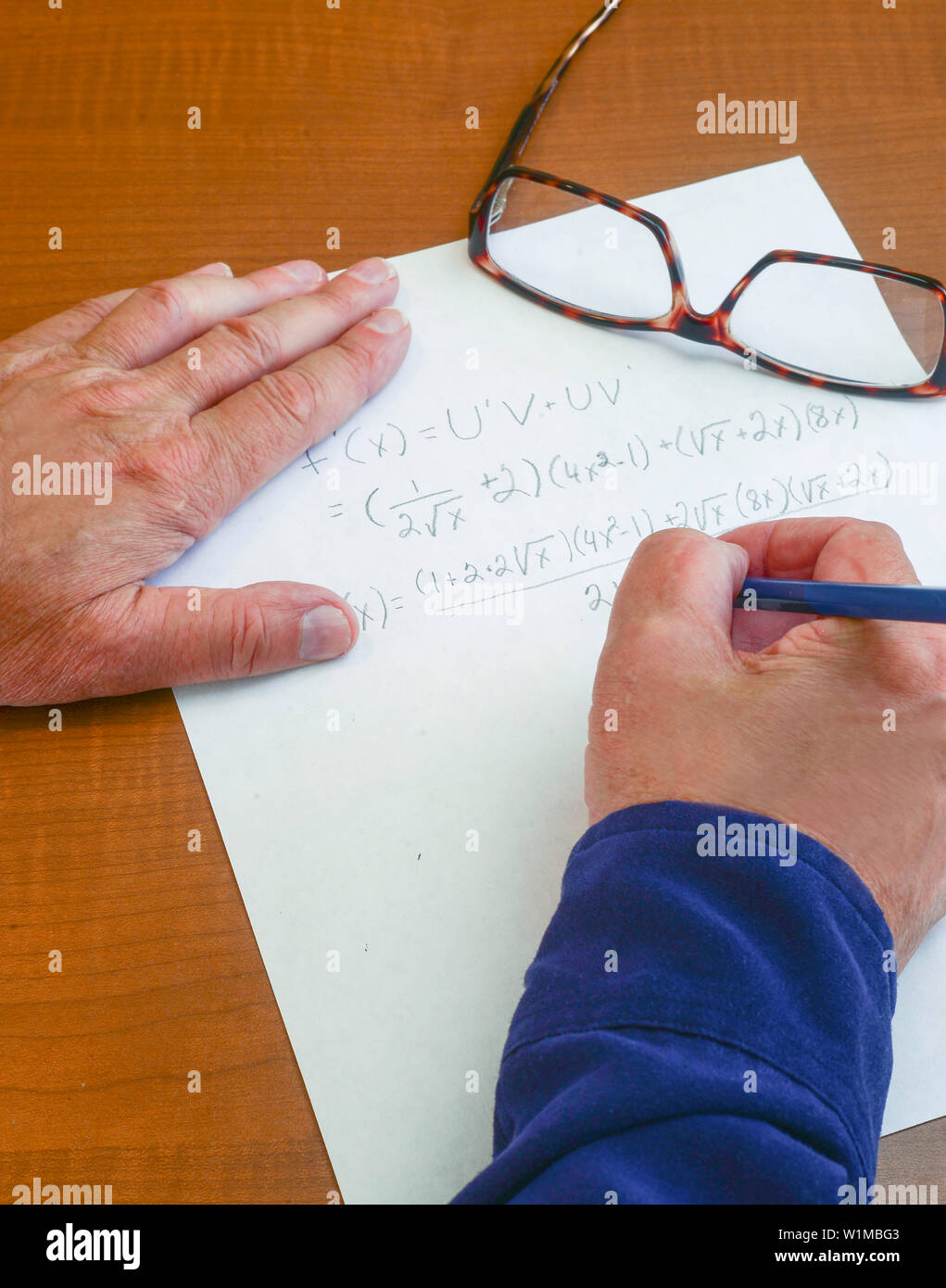 Derivative is worked out to find a true proof that the equation works . Stock Photo
