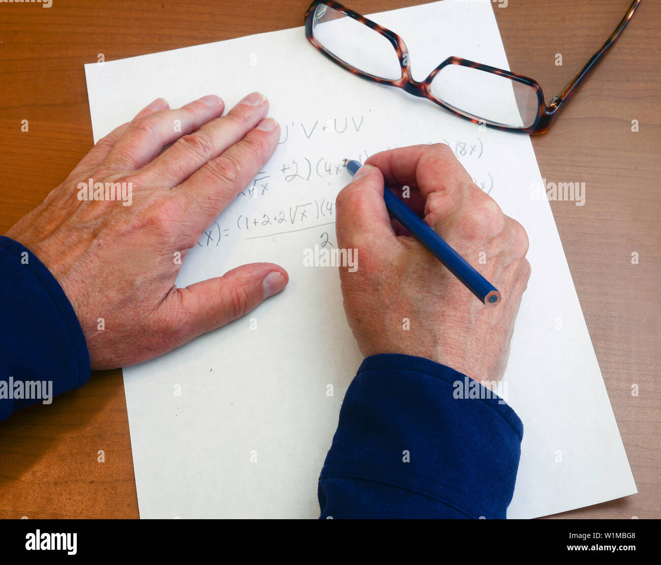 Derivative is worked out to find a true proof that the equation works . Stock Photo