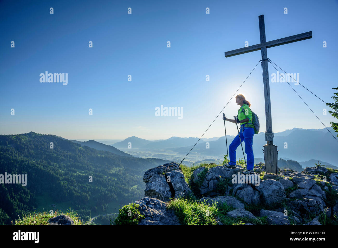 Woman hiking standing on Besler and looking towards valley of Il, Besler, valley of Balderschwang, Allgaeu Alps, Allgaeu, Svabia, Bavaria, Germany Stock Photo