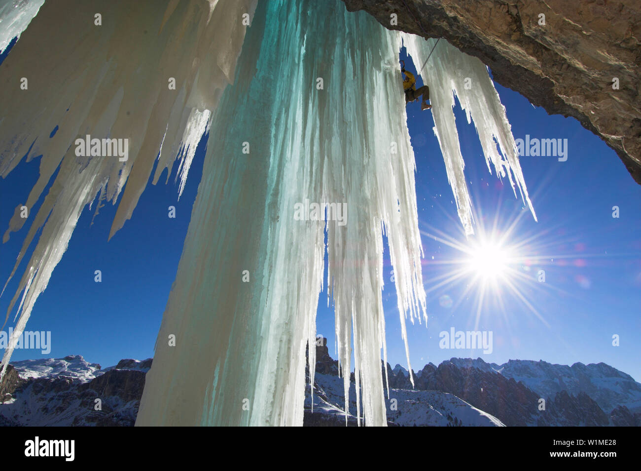 Ice climber on icy rock face, Langental valley, Dolomites, Trentino-Alto Adige, Italy Stock Photo