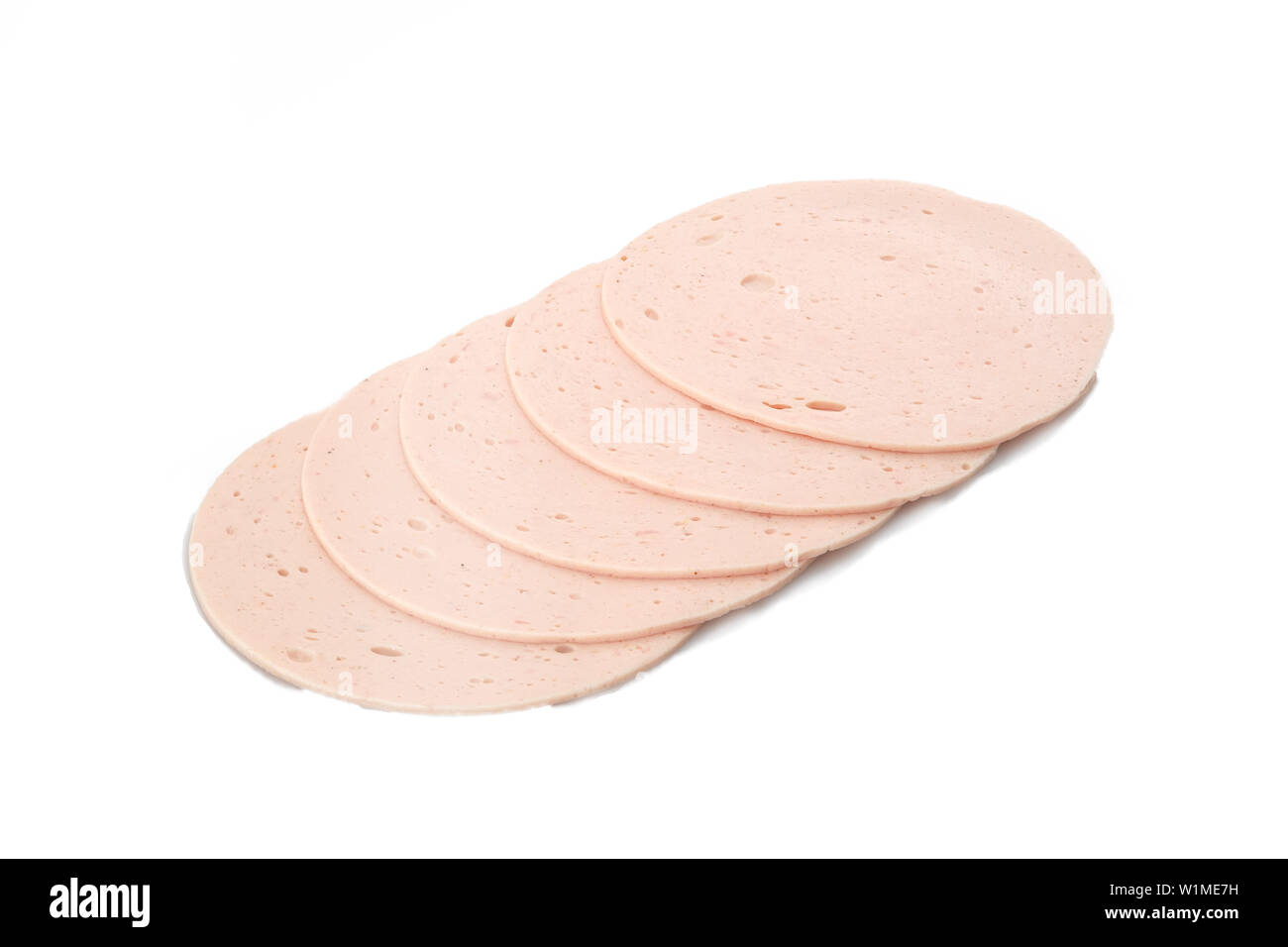 Lyoner sausage ring bologna in slices white isolated Stock Photo - Alamy