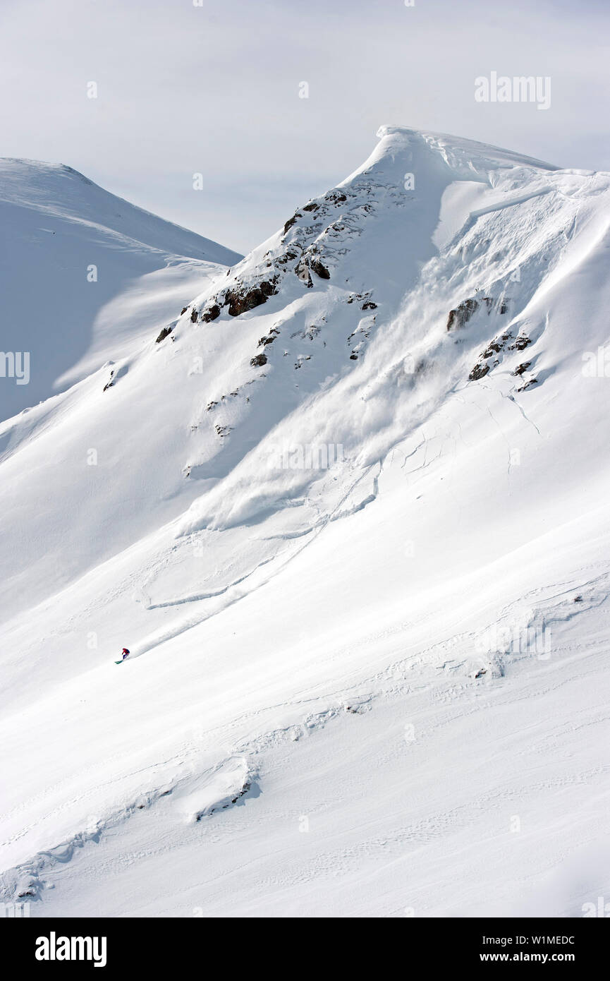 Freerider downhill skiing, avalance in background, Hochfuegen, Fugenberg, Zillertal, Tyrol, Austria Stock Photo
