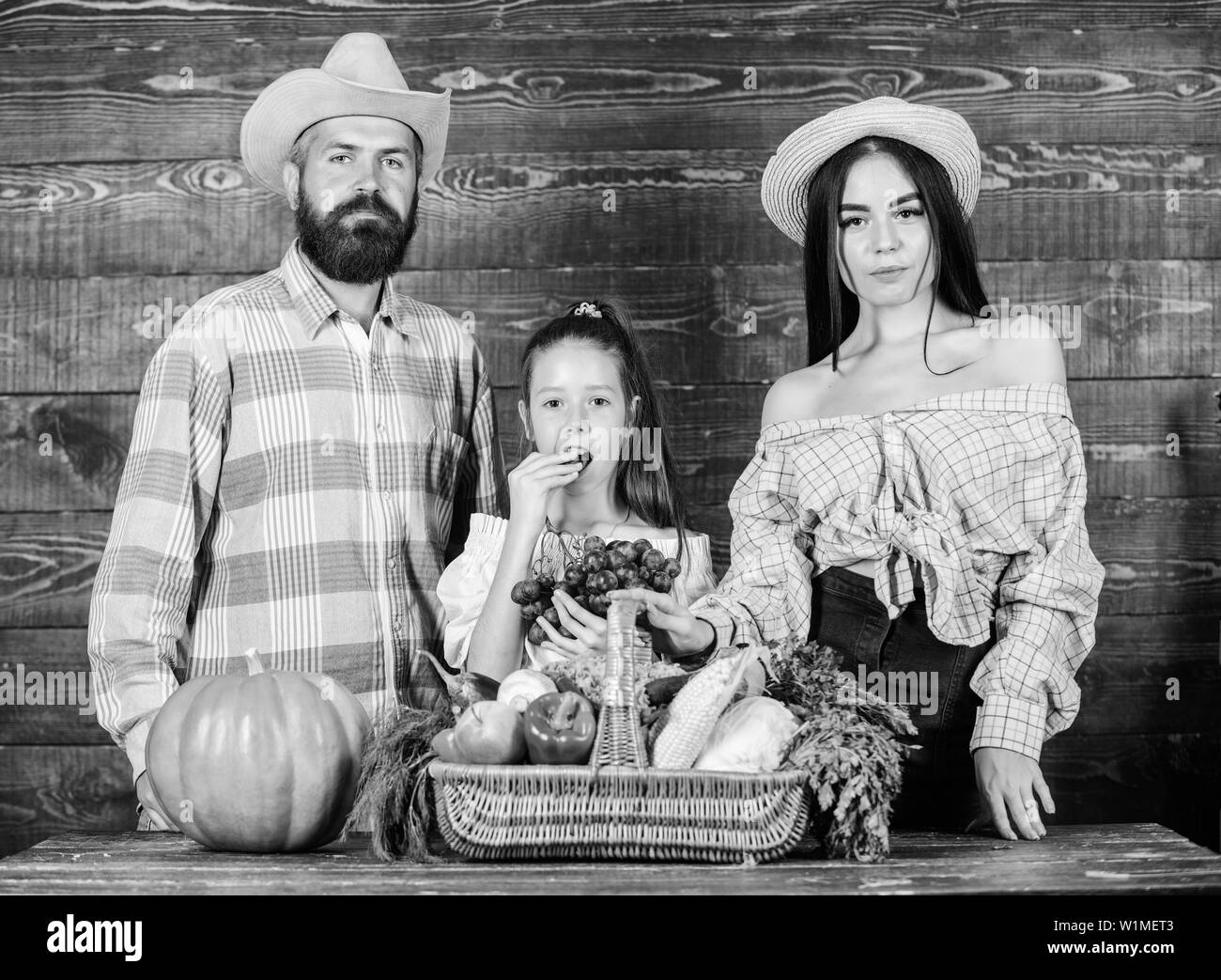 Harvest festival concept. Family farmers with harvest wooden background ...