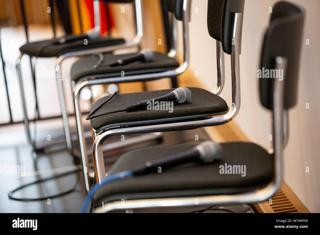 Berlin, Germany. 03rd July, 2019. Mirkos for a panel discussion are on chairs at the opening ceremony of the Master's degree course "Intelligence and Security Studies" for intelligence service employees at the headquarters of the Federal Intelligence Service (BND). (The panel discussion was not allowed to be photographed for security reasons.) Credit: Christoph Soeder/dpa/Alamy Live News Stock Photo