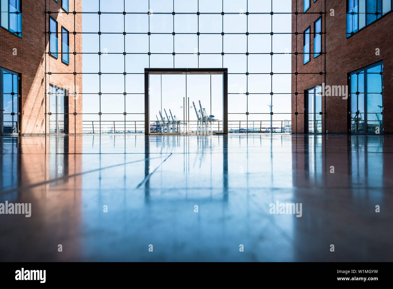 The inner courtyard of the office house Elbflorenz in Grosse Elbstrasse in the old timber harbour with view to container cranes, Hamburg, Germany Stock Photo