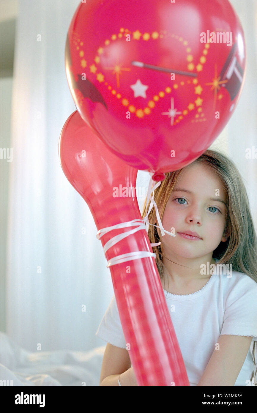 Girl holding red balloons, portrait Stock Photo Alamy