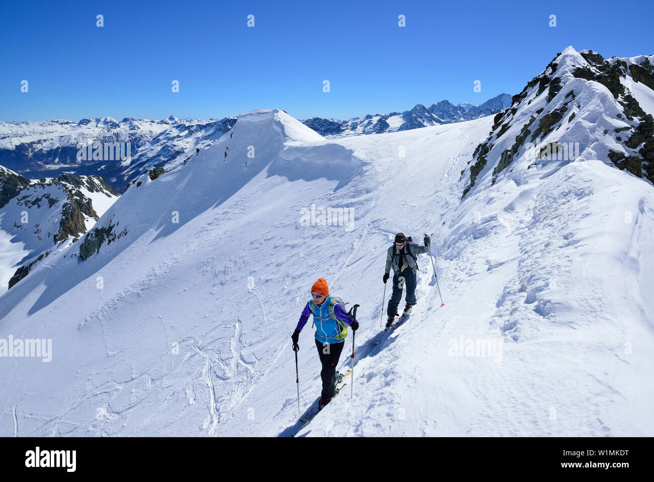 Two back-country skiers ascending to Piz Lagrev, Oberhalbstein Alps, Engadin, Canton of Graubuenden, Switzerland Stock Photo