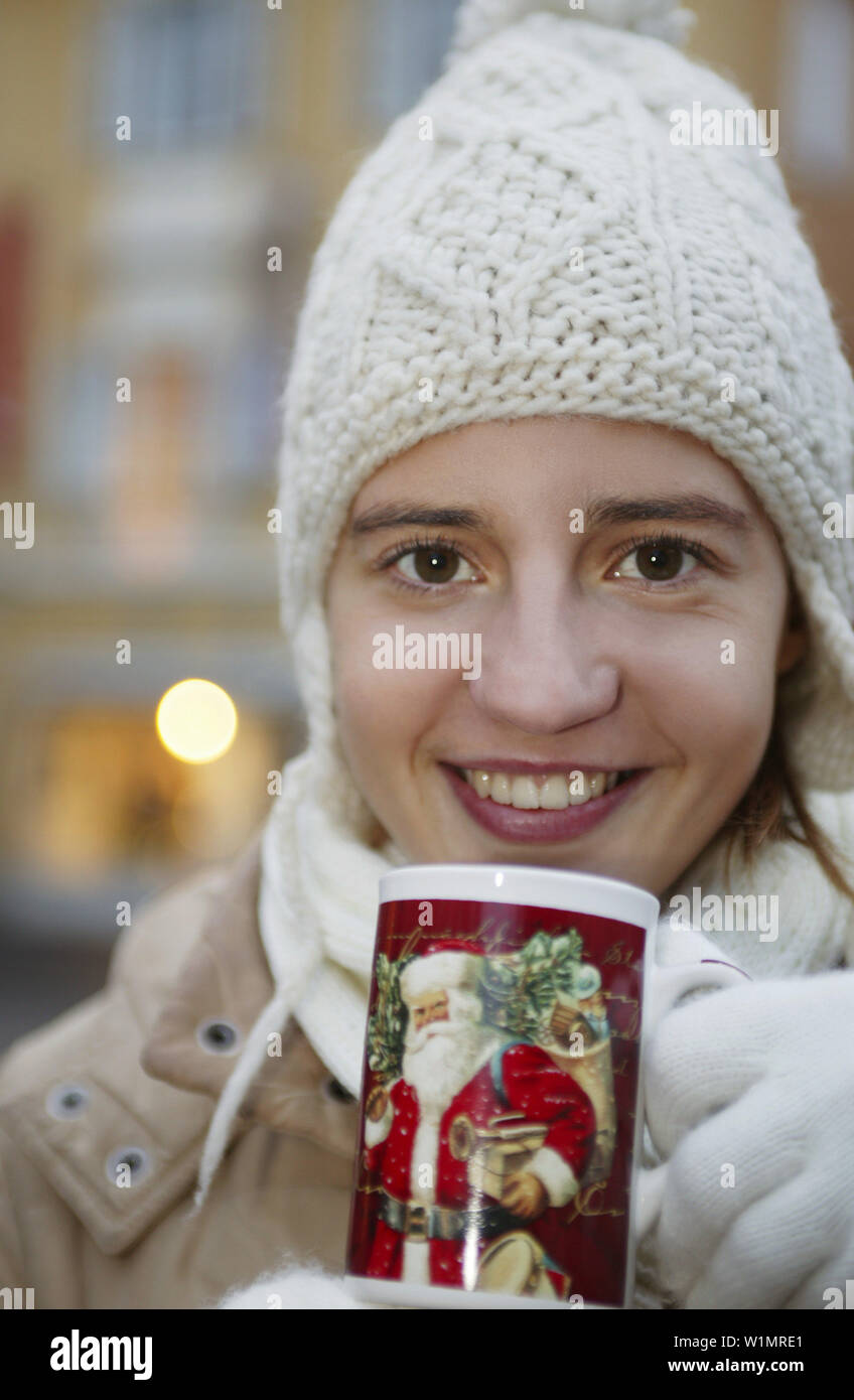 Girl with cap drinking tea, Winter Christmas Coldness Stock Photo