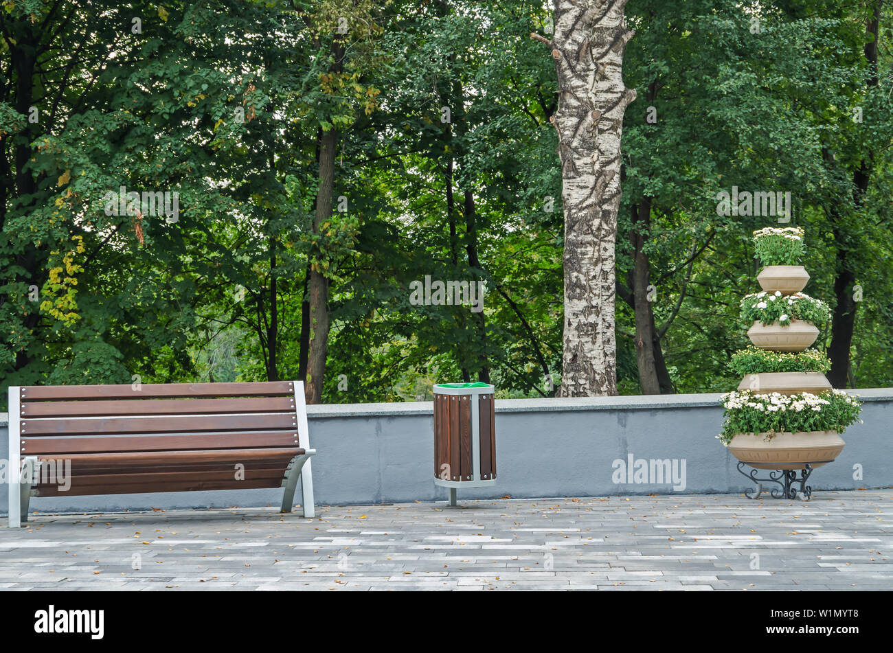 A Wooden Bench For Rest Garbage Bin For Waste And Basket Of