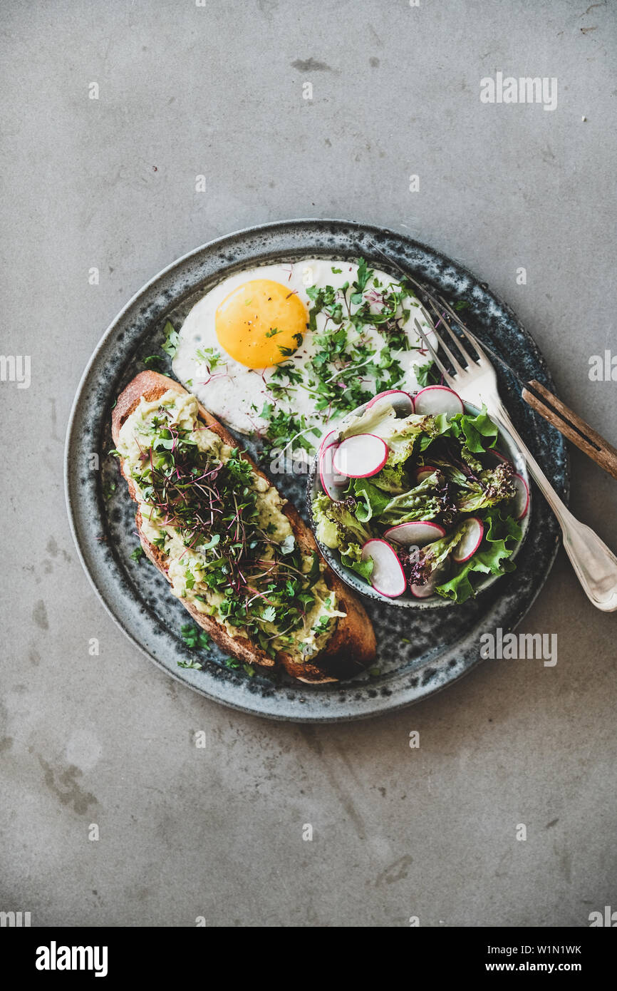 Healthy trendy breakfast plate over grey concrete background Stock Photo