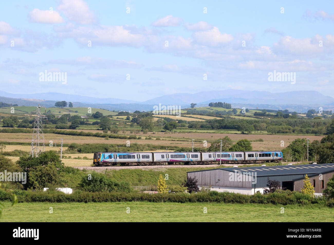 Siemens Desiro class 350 electric multiple-unit train in TransPennine Express livery on West Coast Main Line near Holme, Cumbria on 3rd July 2019. Stock Photo