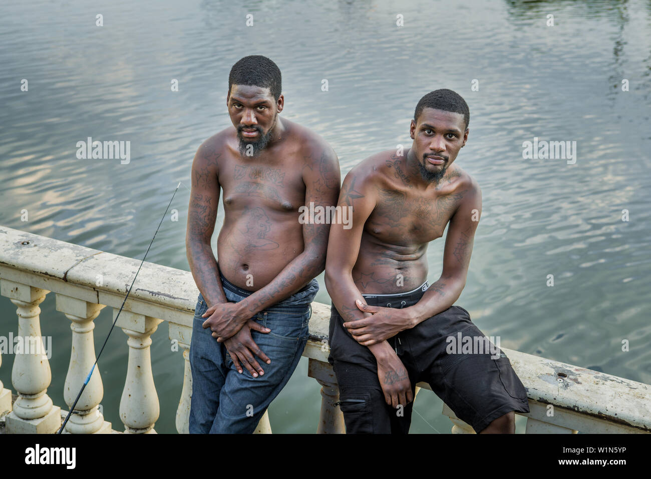 2 African American men pause from  fishing on the Schuylkill River by the Philadelphia Art Museum Stock Photo