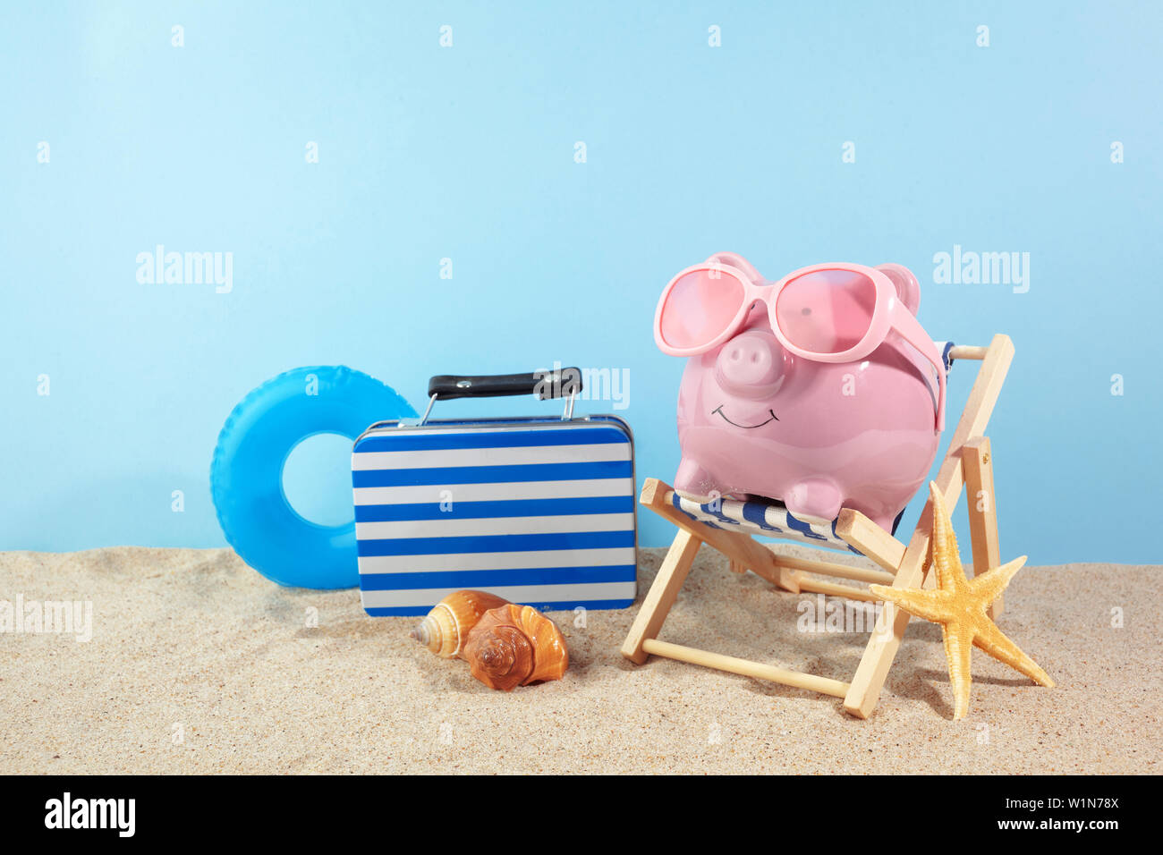 Piggy bank with sunglasses on the sand background Stock Photo - Alamy
