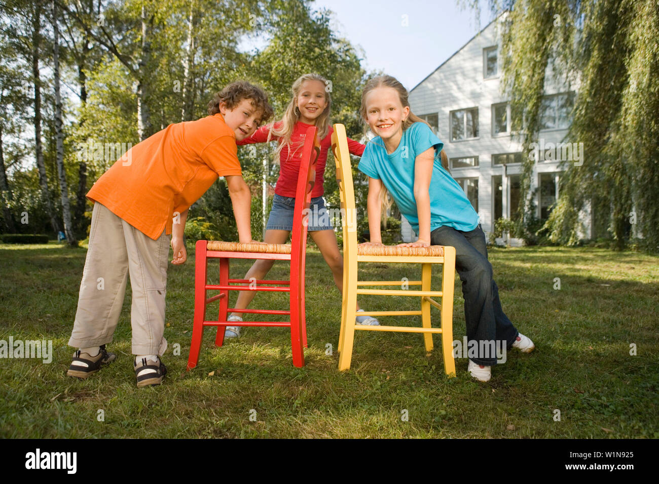 Children playing Musical Chairs, children's birthday party Stock Photo