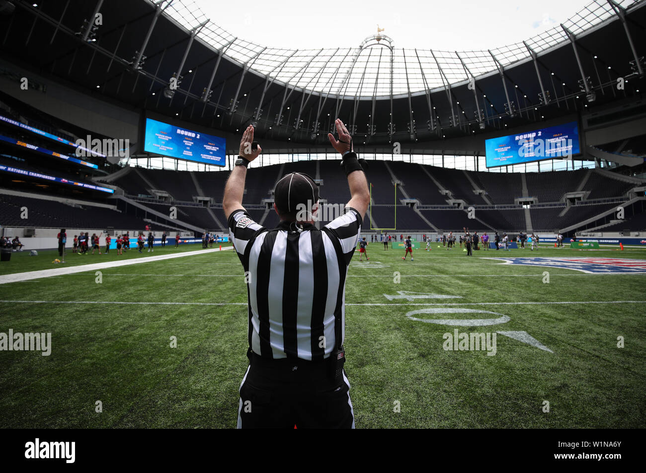 U.S. service members with the RAF Molesworth Honor Guard uncase the colors  of the American flag before the start of the International Series, Miami  Dolphins versus New York Jets NFL game at