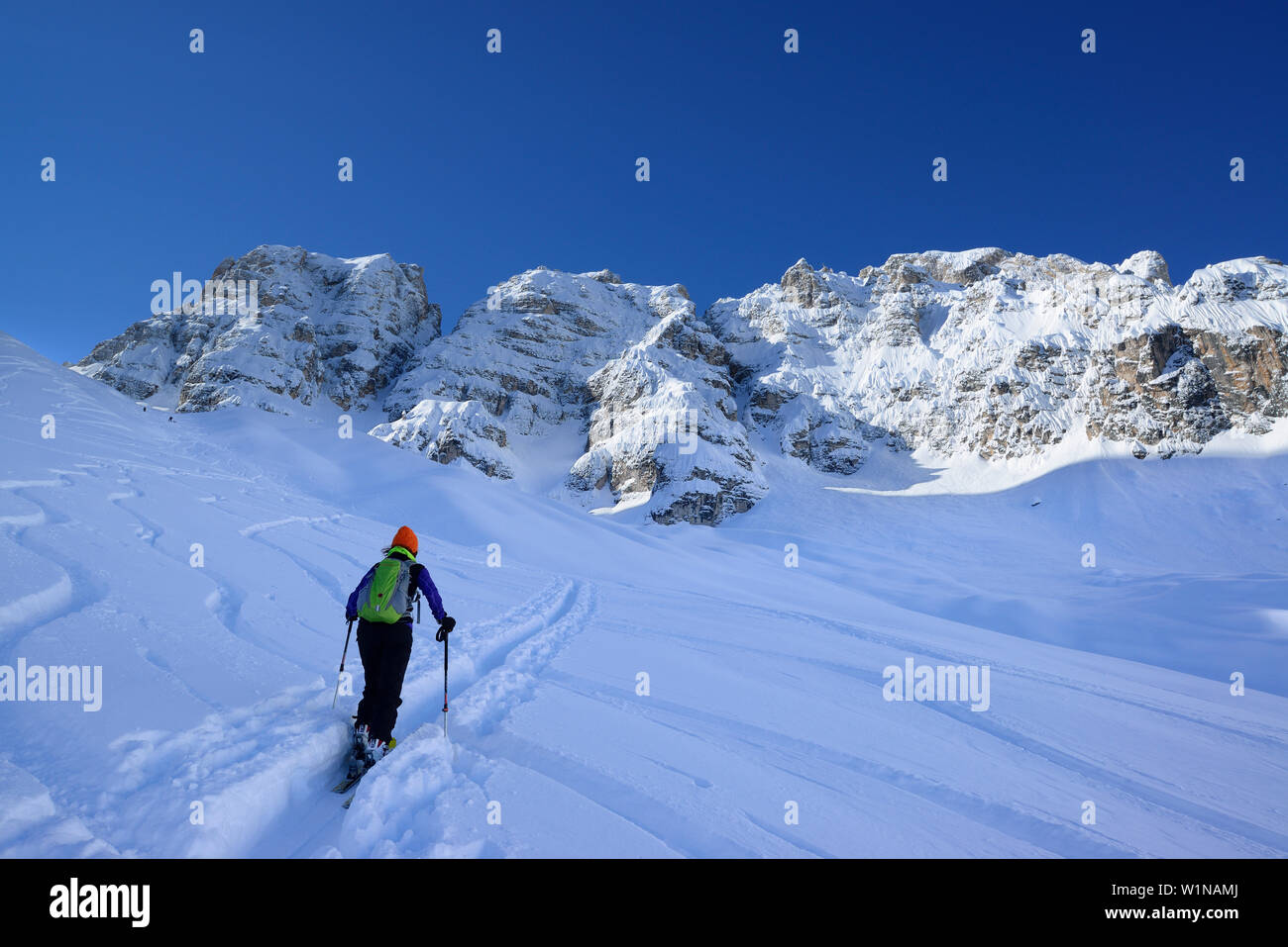 Female back-country skier ascending to Cristallo wind gap, Cristallo, Dolomites, Belluno, Veneto, Italy Stock Photo