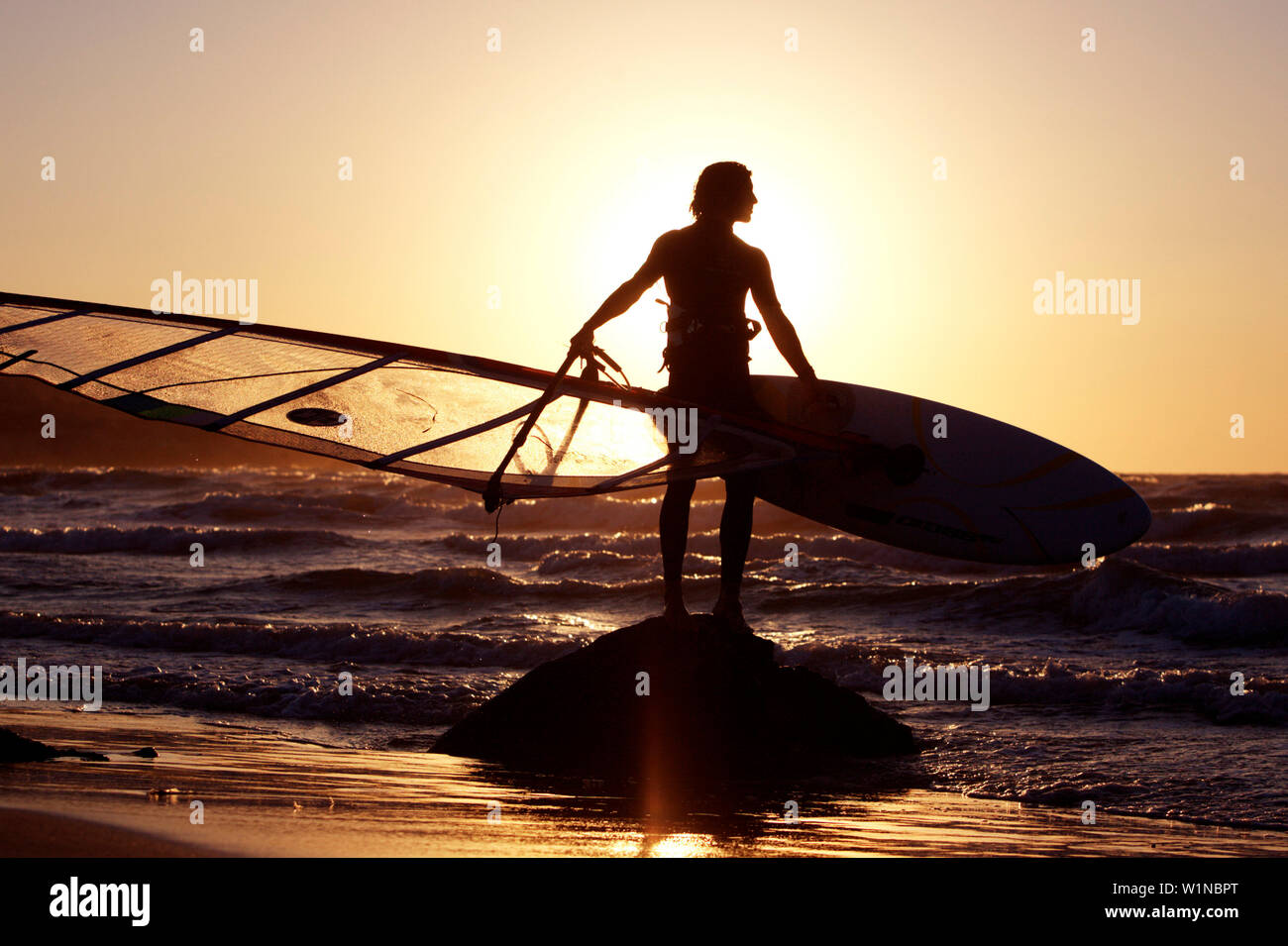 Windsurfer standing on the beach with his surfboard, Kos, Greece Stock Photo