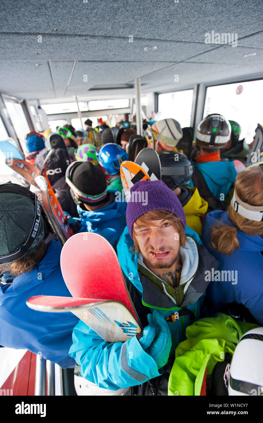 Skiers inside an overhead cable car cabin, Chamonix, Rhone-Alpes, France Stock Photo