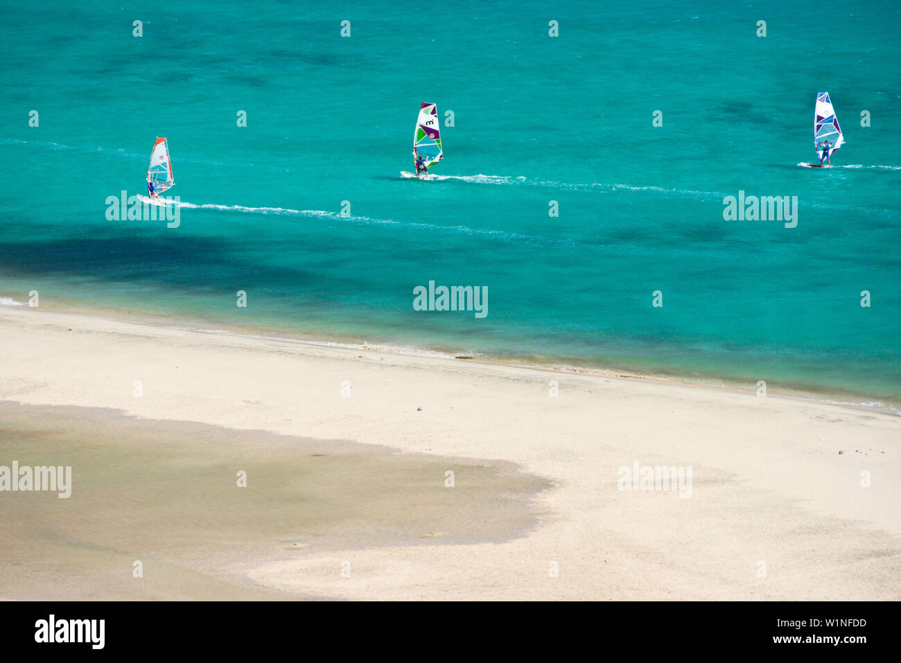 Surfers and bathing vistitors at the beach, Playas de Sotavento de Jandia, Risco del Paso, Fuerteventura, Canary Islands, Spain Stock Photo