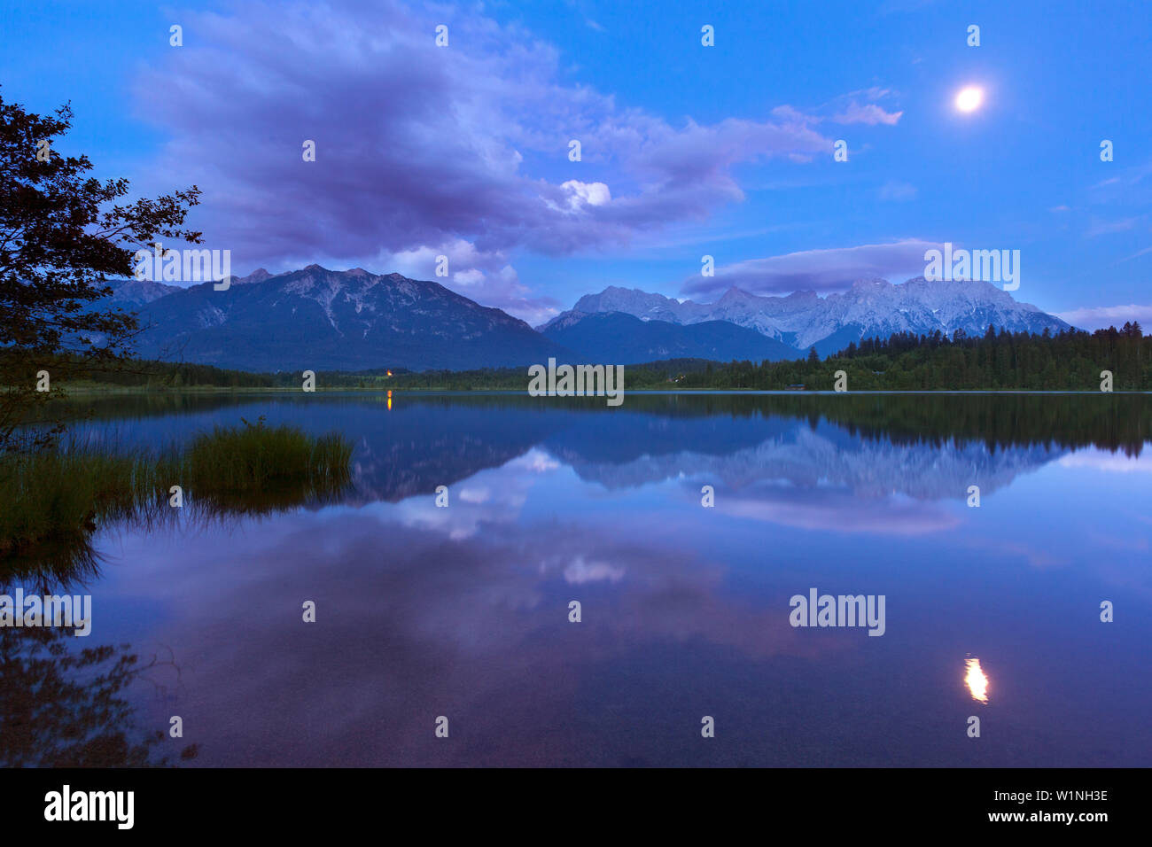 Full moon reflecting in lake Barmsee, view to Soierngruppe and ...