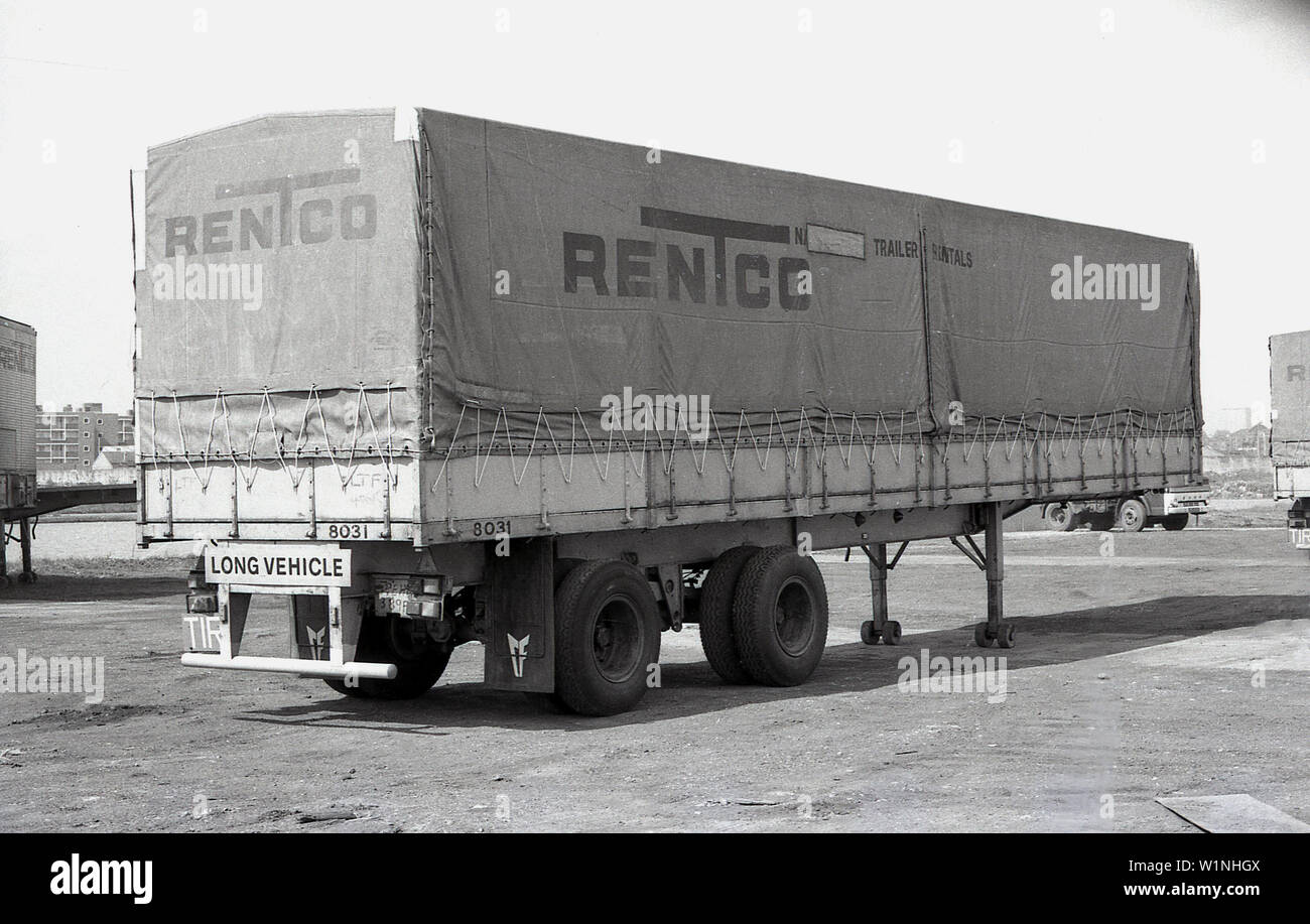 1970s, historical, a trailer of a truck parked outside in a industrial