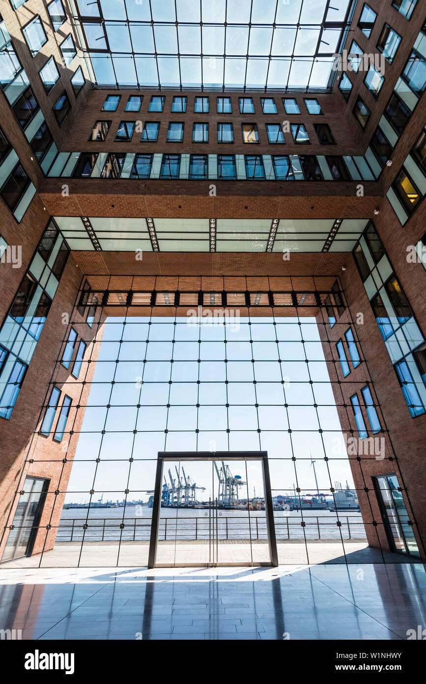 The inner courtyard of the office house Elbflorenz in Grosse Elbstrasse in the old timber harbour with view at container cranes, Hamburg, Germany Stock Photo