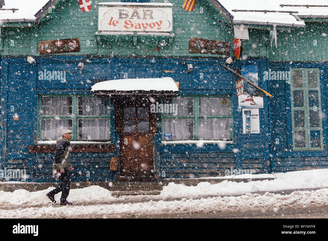 Man in snow outside a bar, Argentiere, France Stock Photo