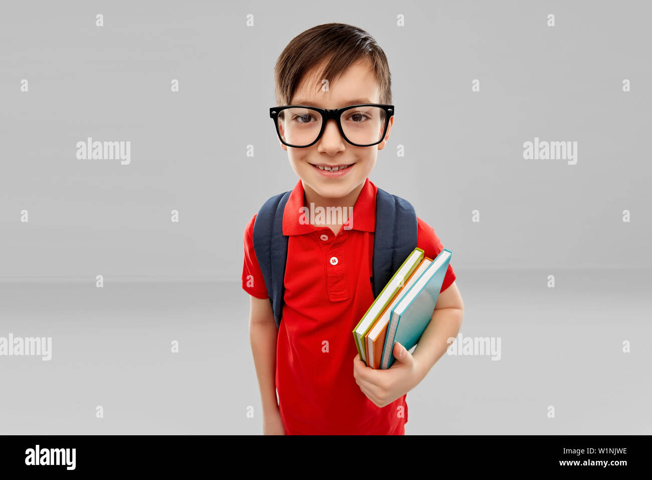 smiling student boy in glasses with books and bag Stock Photo - Alamy