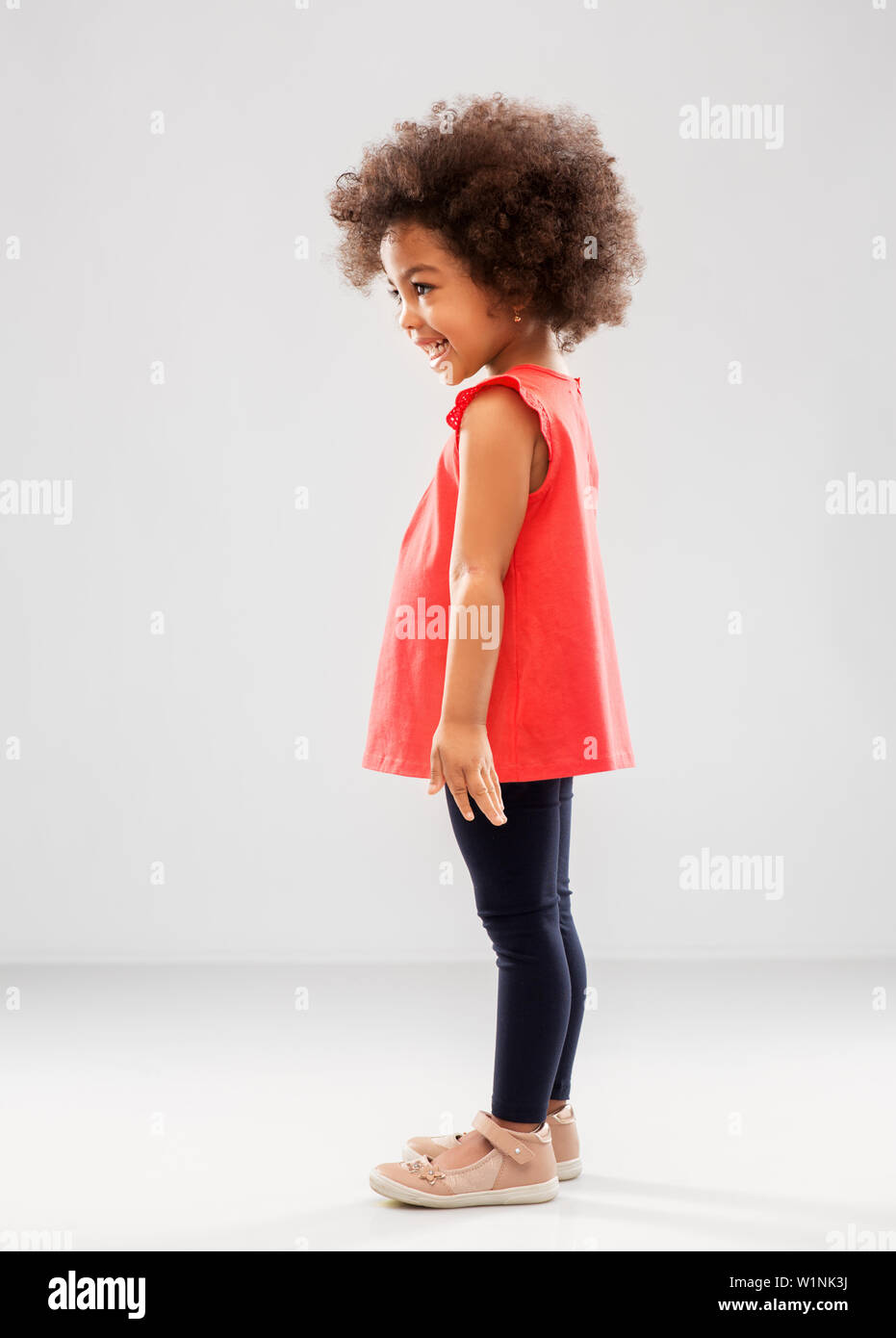 happy little african american girl over grey Stock Photo - Alamy